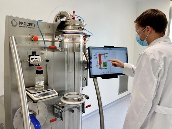 Scientist working with pharmaceutical spray drying equipment